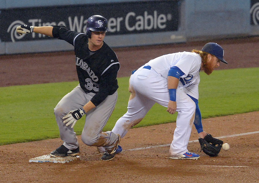 Colorado Rockies first baseman Justin Morneau (33) swings at the