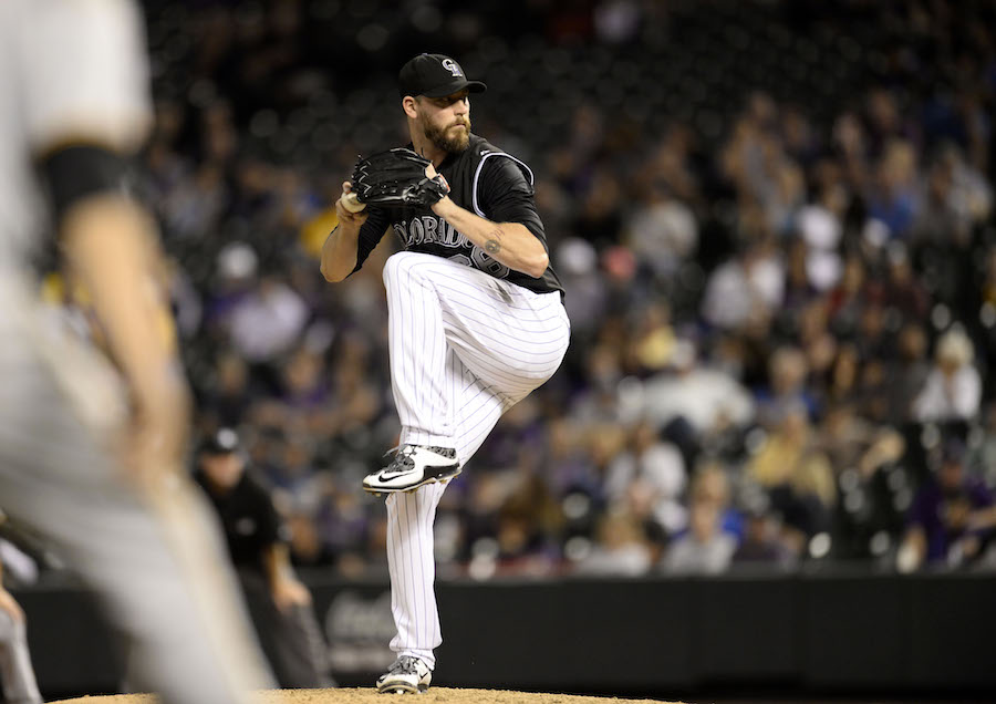Sep 23, 2015; Denver, CO, USA; Colorado Rockies relief pitcher John Axford (66) prepares to deliver a pitch with the bases loaded in the ninth inning against the Pittsburgh Pirates at Coors Field. The Pirates defeated the Rockies 13-7. Mandatory Credit: Ron Chenoy-USA TODAY Sports