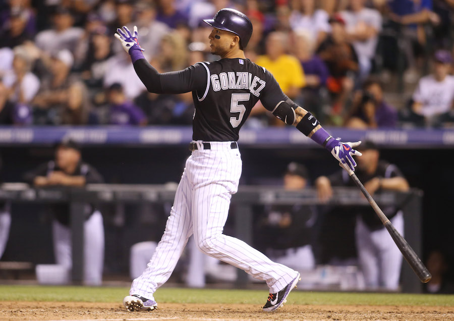 Sep 26, 2015; Denver, CO, USA; Colorado Rockies right fielder Carlos Gonzalez (5) hits a walk off two run home run during the ninth inning against the Los Angeles Dodgers at Coors Field. The Rockies won 8-6. Mandatory Credit: Chris Humphreys-USA TODAY Sports