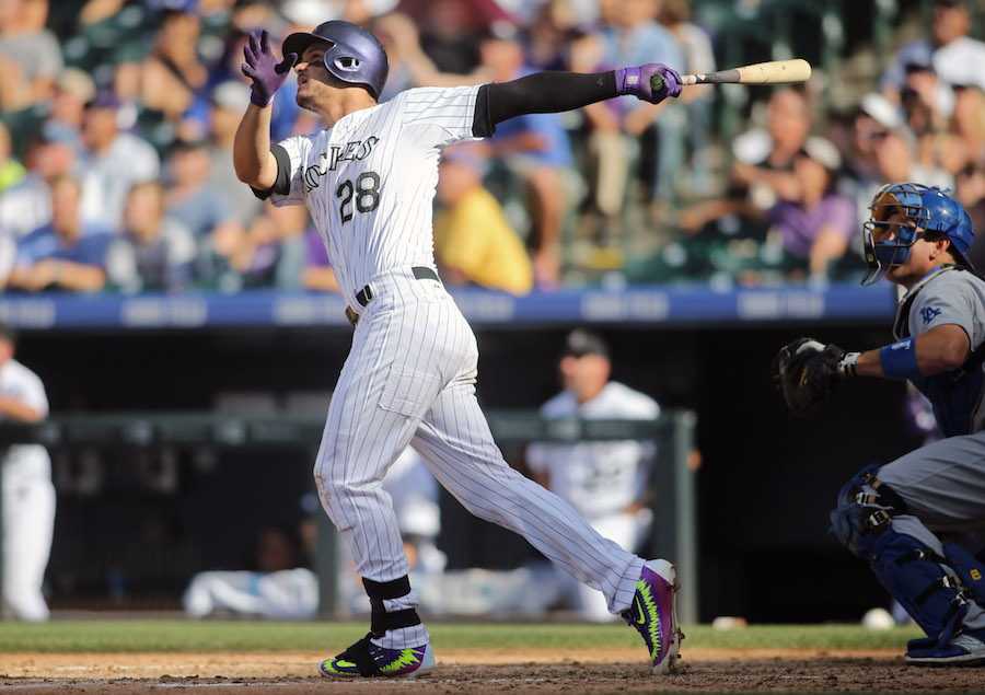 Sep 27, 2015; Denver, CO, USA; Colorado Rockies third baseman Nolan Arenado (28) hits a home run during the fourth inning against the Los Angeles Dodgers at Coors Field. The Rockies won 12-5. Mandatory Credit: Chris Humphreys-USA TODAY Sports