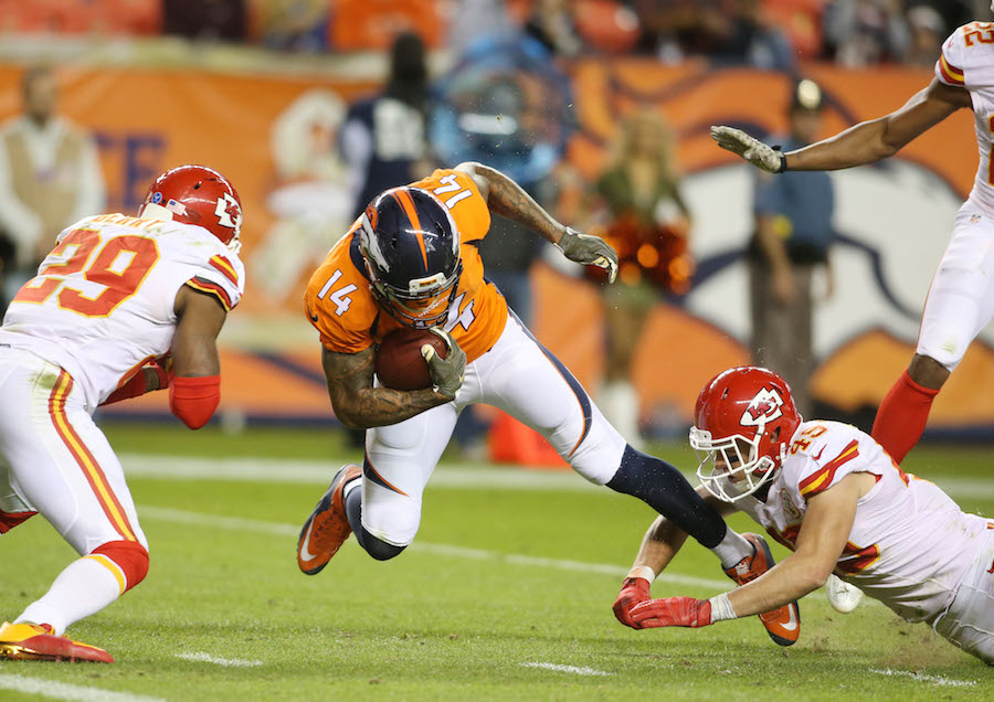Nov 15, 2015; Denver, CO, USA; Denver Broncos wide receiver Cody Latimer (14) is brought down near the goal line by Kansas City Chiefs defensive back Daniel Sorensen (49) and free safety Eric Berry (29) during the second half at Sports Authority Field at Mile High. The Chiefs won 29-13. Mandatory Credit: Chris Humphreys-USA TODAY Sports