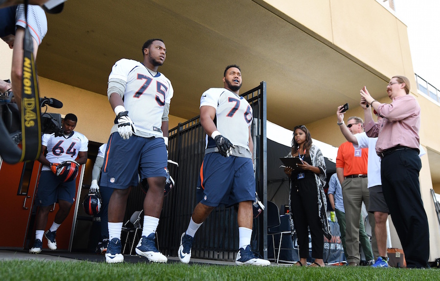 Jul 28, 2016; Englewood, CO, USA; Denver Broncos offensive tackle Cameron Jefferson (75) and offensive guard Max Garcia (76) walk onto the field before the start of training camp drills held at the UCHealth Training Center. Mandatory Credit: Ron Chenoy-USA TODAY Sports