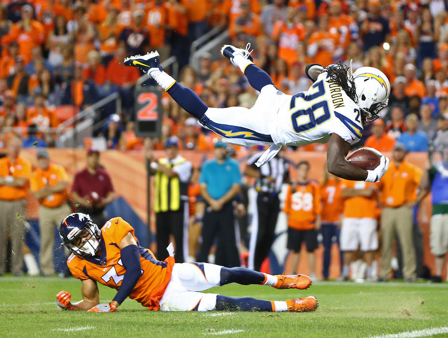 NFL: Los Angeles Chargers at Denver Broncos Los Angeles Chargers running back Melvin Gordon (31) leaps over Denver Broncos safety Justin Simmons (31) to score in the second quarter at Sports Authority Field.