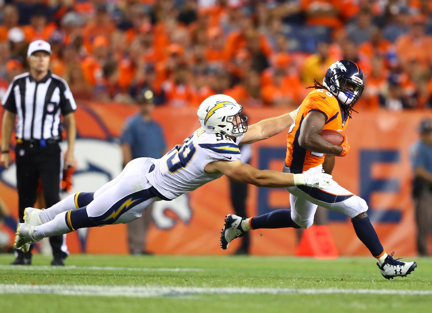 Sep 11, 2017; Denver, CO, USA; Denver Broncos running back Jamaal Charles (28) avoids the tackle by diving Los Angeles Chargers defensive end Joey Bosa in the second half at Sports Authority Field at Mile High. Mandatory Credit: Mark J. Rebilas-USA TODAY Sports