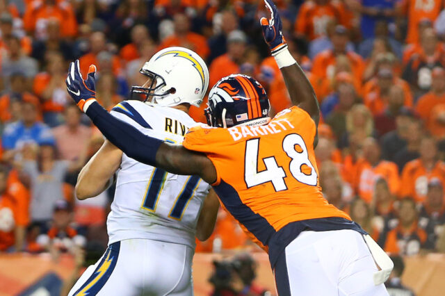Denver Broncos linebacker Shaquil Barrett (48) sacks Los Angeles Chargers quarterback Philip Rivers (17) in the second half at Sports Authority Field at Mile High.