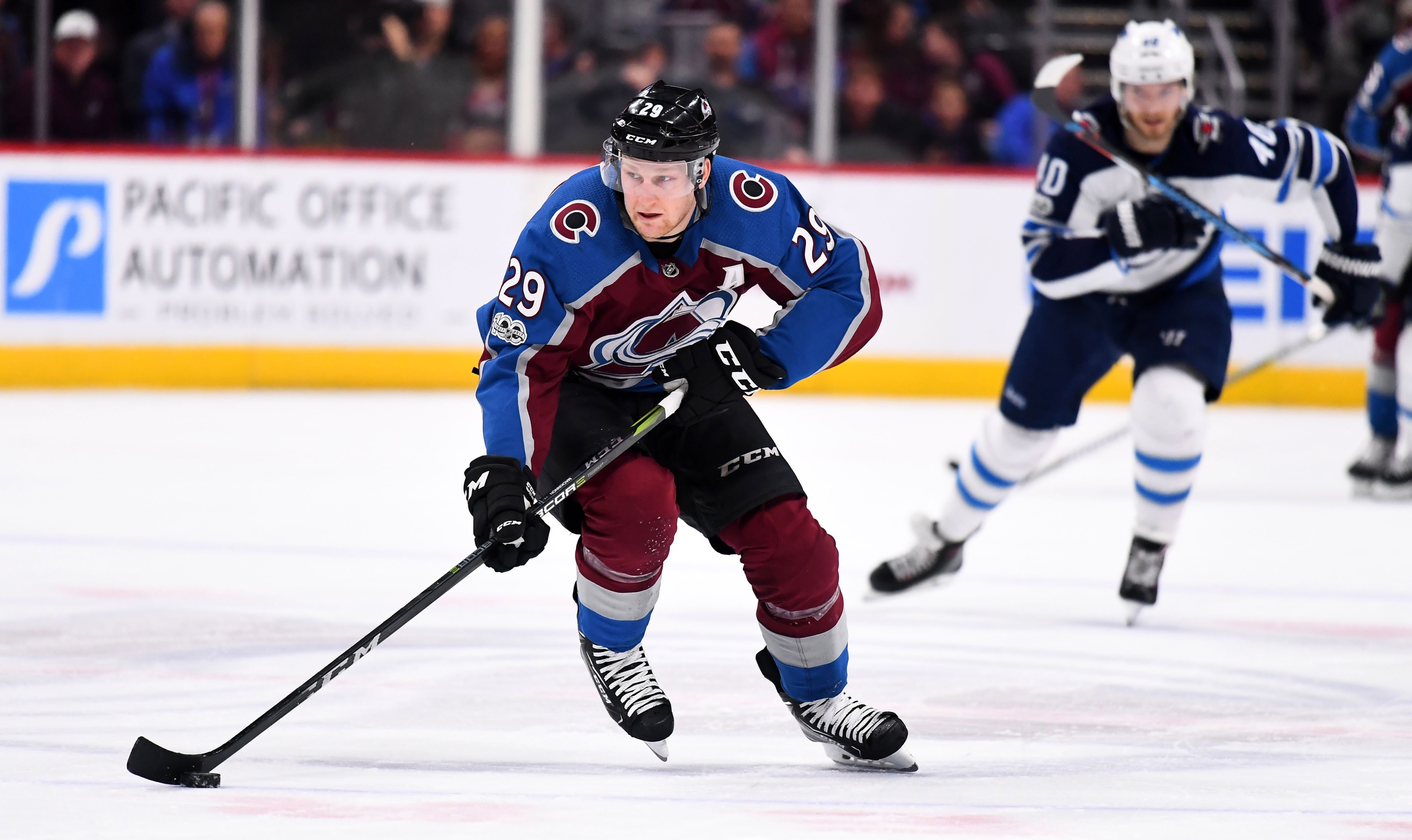 Nov 29, 2017; Denver, CO, USA; Colorado Avalanche center Nathan MacKinnon (29) controls the puck in the second period against the Winnipeg Jets at the Pepsi Center. Mandatory Credit: Ron Chenoy-USA TODAY Sports