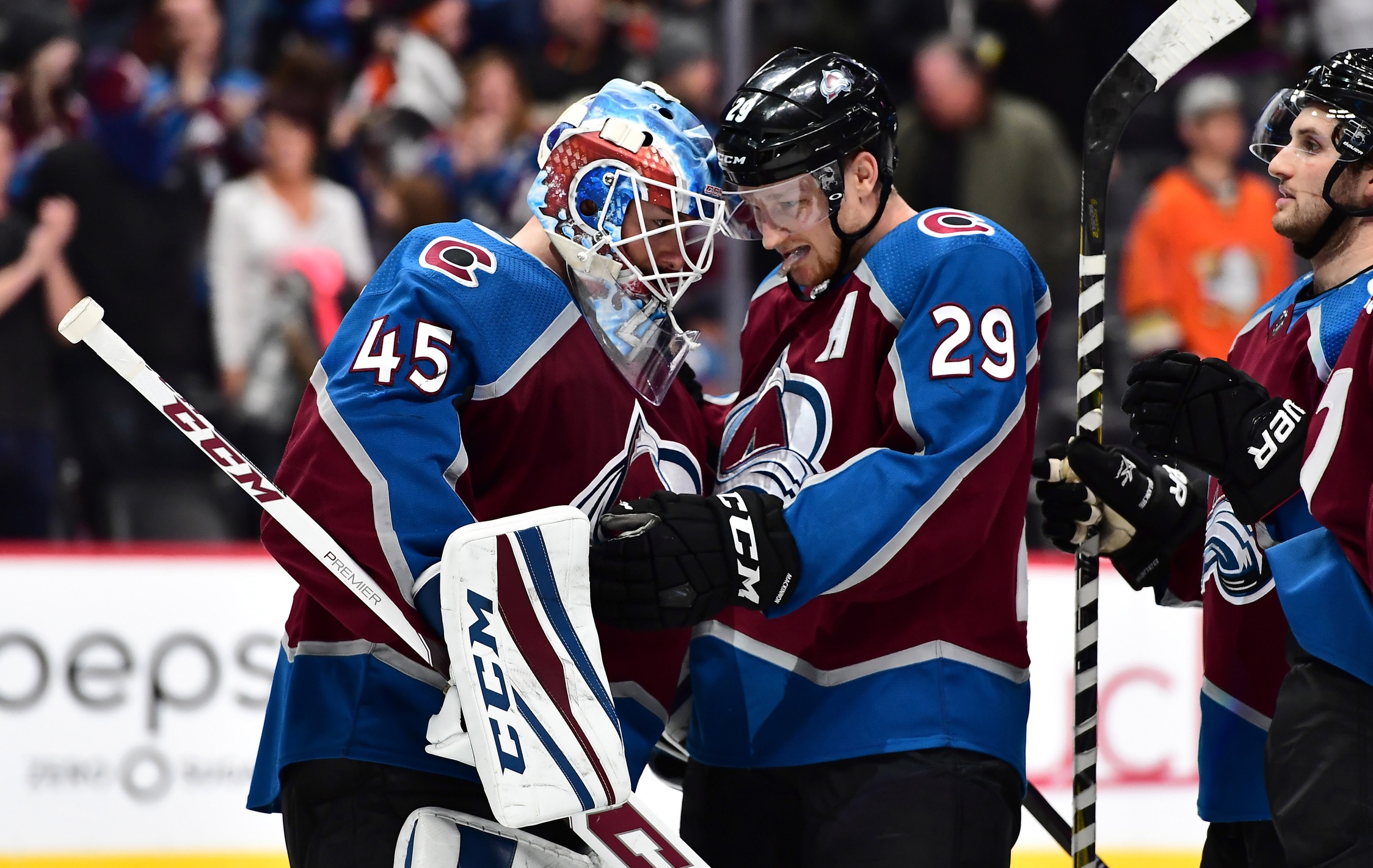 Jan 15, 2018; Denver, CO, USA; Colorado Avalanche goaltender Jonathan Bernier (45) and center Nathan MacKinnon (29) celebrate a victory over the Anaheim Ducks at the Pepsi Center. Mandatory Credit: Ron Chenoy-USA TODAY Sports