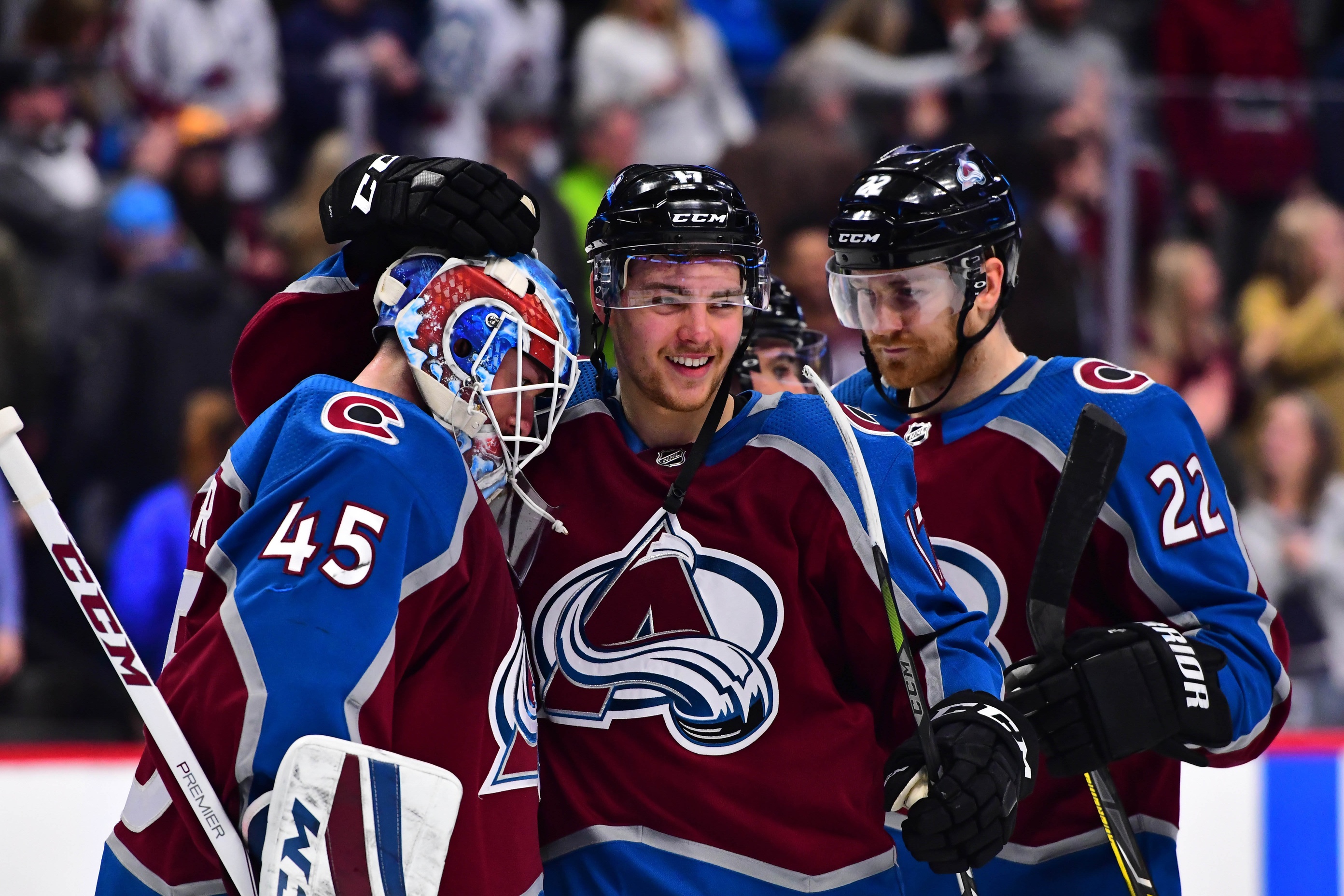 Feb 6, 2018; Denver, CO, USA; Colorado Avalanche goaltender Jonathan Bernier (45) and center Tyson Jost (17) and center Colin Wilson (22) celebrate the San Jose Sharks at the Pepsi Center. Mandatory Credit: Ron Chenoy-USA TODAY Sports