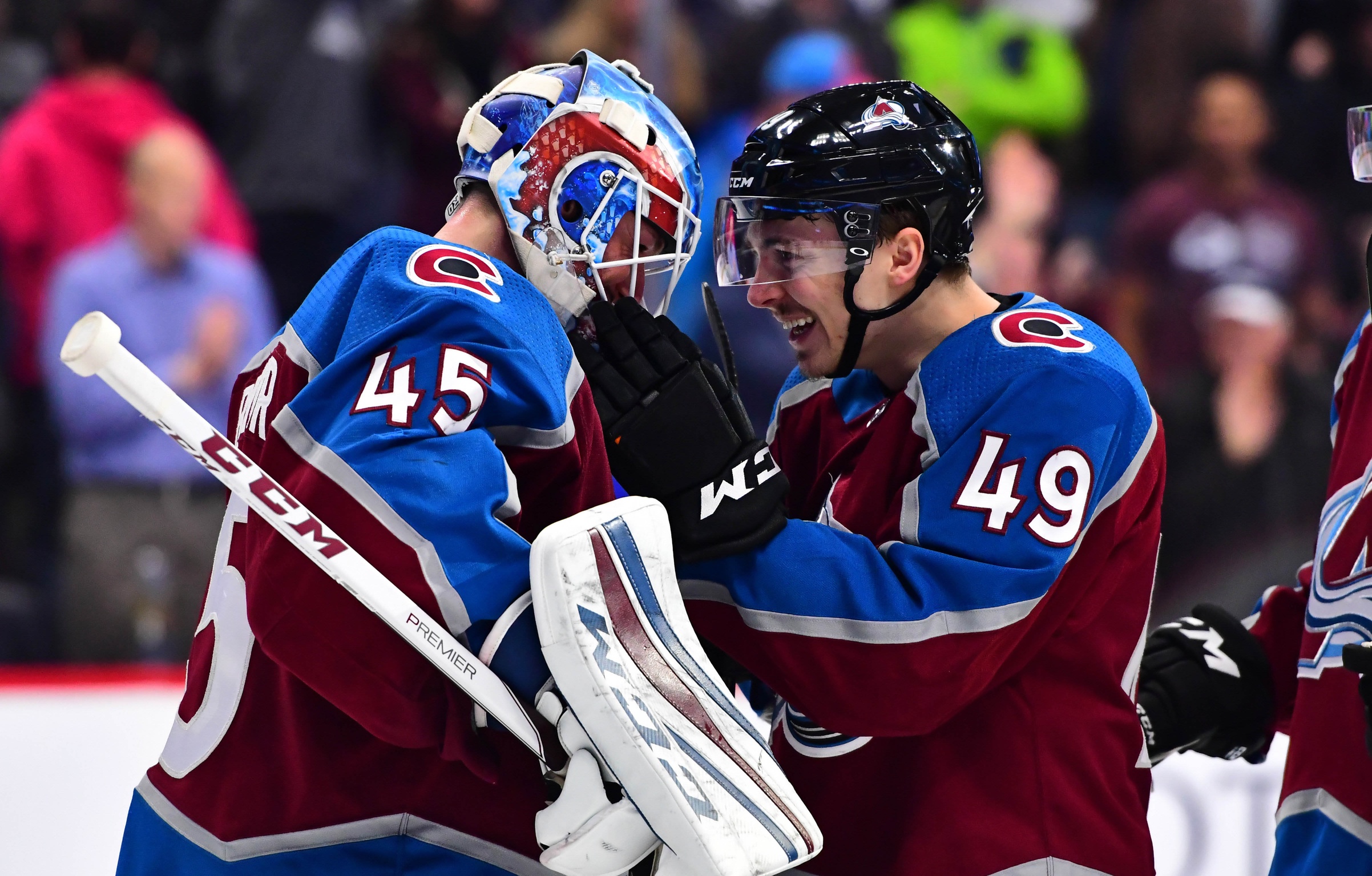 Avalanche goaltender Jonathan Bernier (45) and defenseman Samuel Girard (49) celebrate the 3-1 win over the Sharks at the Pepsi Center. Credit: Ron Chenoy-USA TODAY Sports