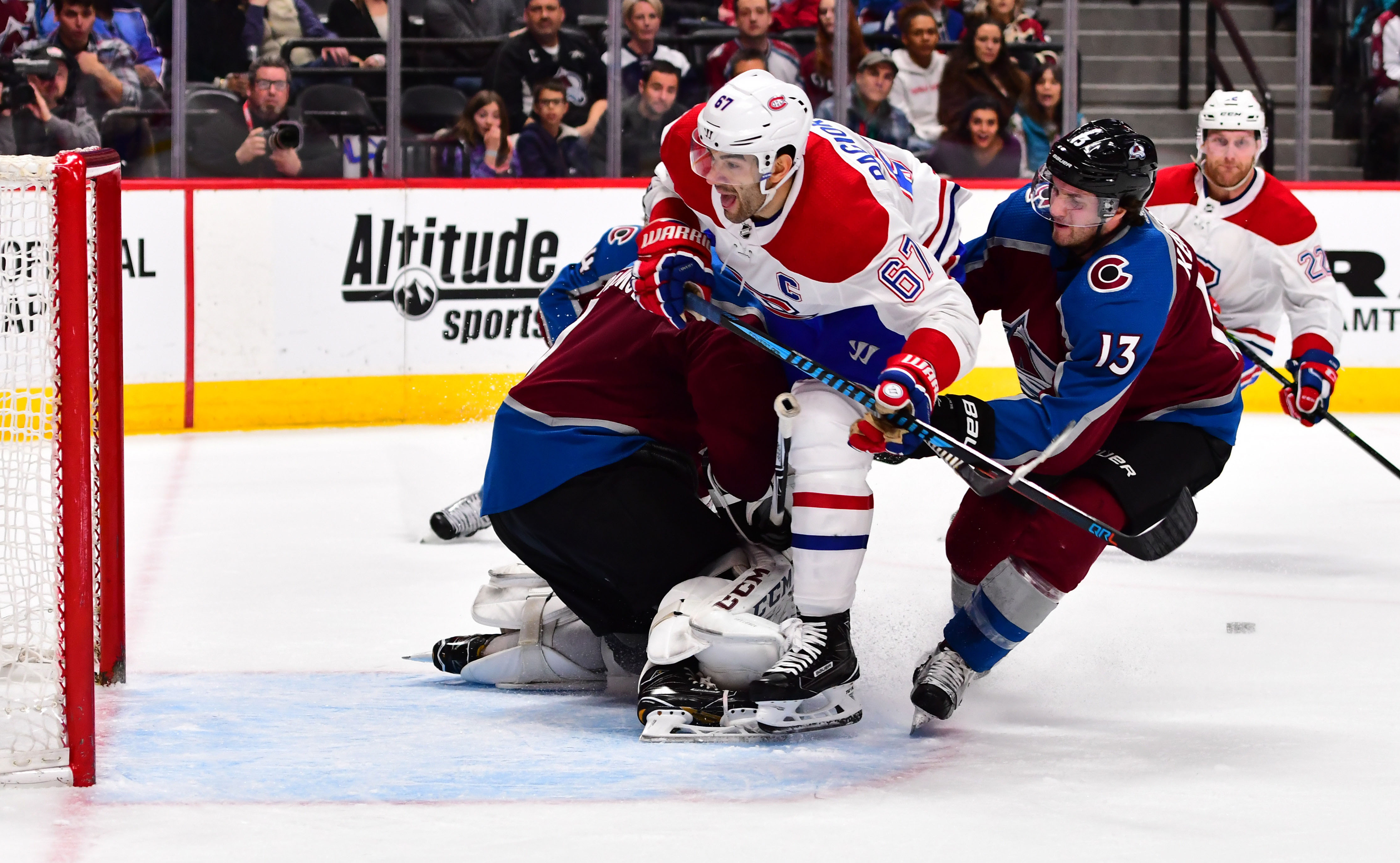 Canadiens left wing Max Pacioretty (67) collides into Colorado Avalanche goaltender Semyon Varlamov (1) as center Alexander Kerfoot (13) defends from behind in the first period at the Pepsi Center. Credit: Ron Chenoy-USA TODAY Sports