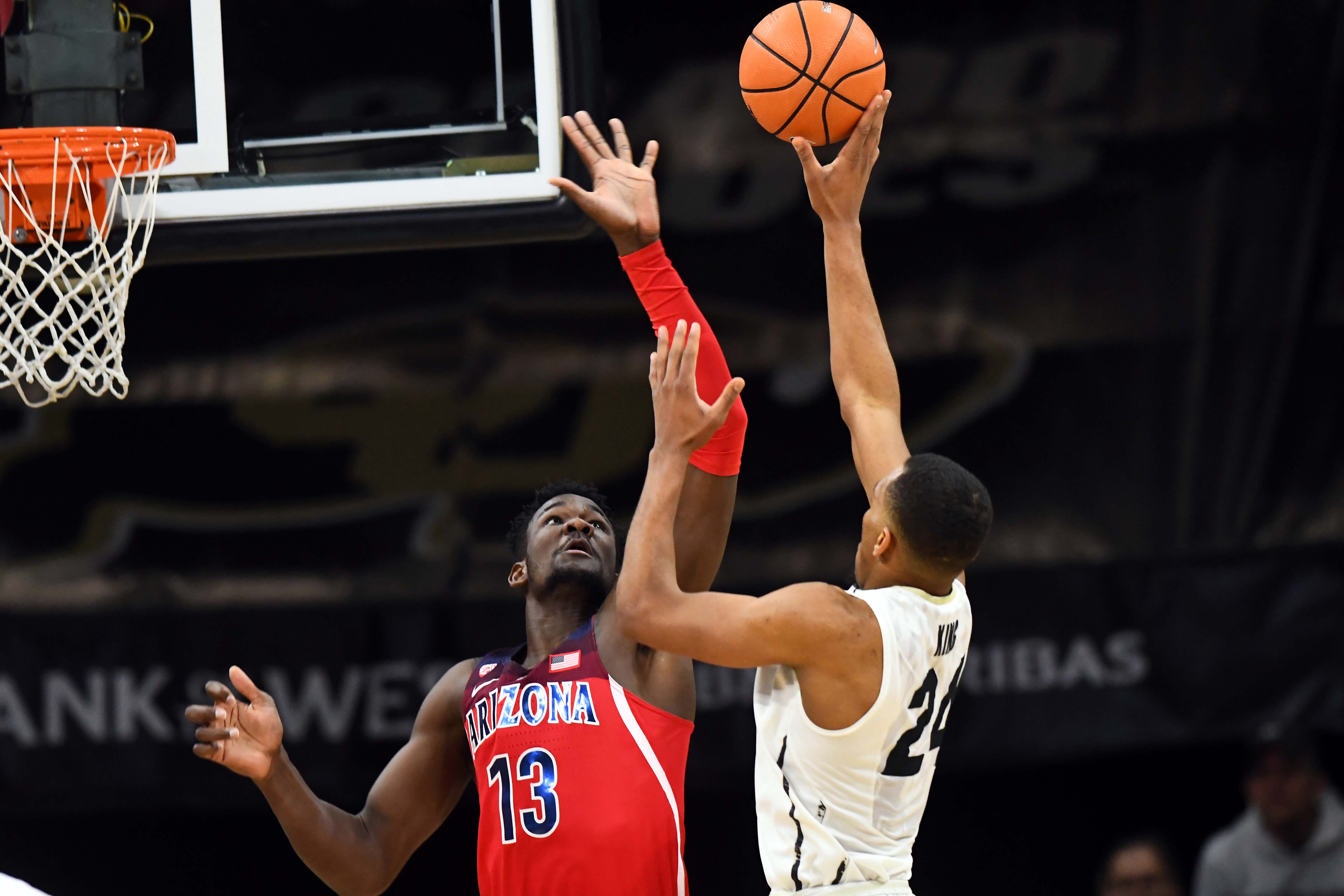 NCAA Basketball: Arizona at Colorado Colorado Buffaloes guard George King (24) attempts a basket over Arizona Wildcats forward Deandre Ayton (13) in the second half at the Coors Events Center.