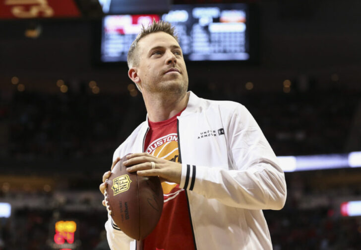 Case Keenum looks to throw a football into the crowd during the game between the Houston Rockets and the San Antonio Spurs at Toyota Center