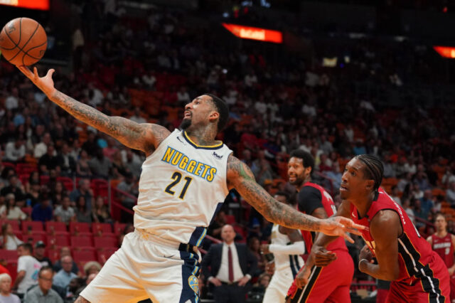 Denver Nuggets forward Wilson Chandler (21) reaches for the ball while being guarded by Miami Heat forward Josh Richardson (0) during the first half at American Airlines Arena.