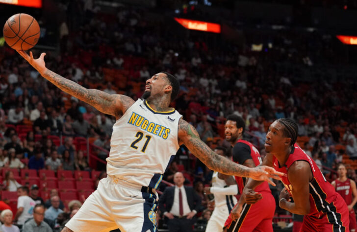 Denver Nuggets forward Wilson Chandler (21) reaches for the ball while being guarded by Miami Heat forward Josh Richardson (0) during the first half at American Airlines Arena.