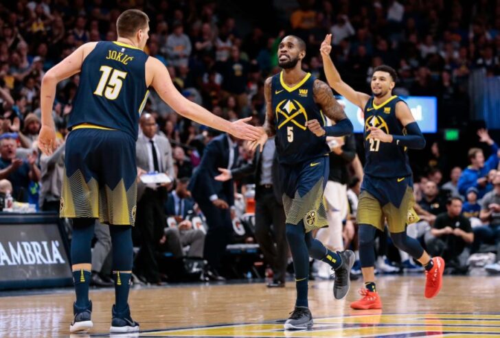 Denver Nuggets guard Will Barton (5) and center Nikola Jokic (15) and guard Jamal Murray (27) celebrate after a play in the fourth quarter against the Golden State Warriors at the Pepsi Center.