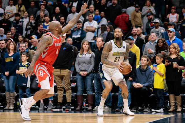 Houston Rockets forward P.J. Tucker (4) guards Denver Nuggets forward Wilson Chandler (21) in the first quarter at the Pepsi Center.