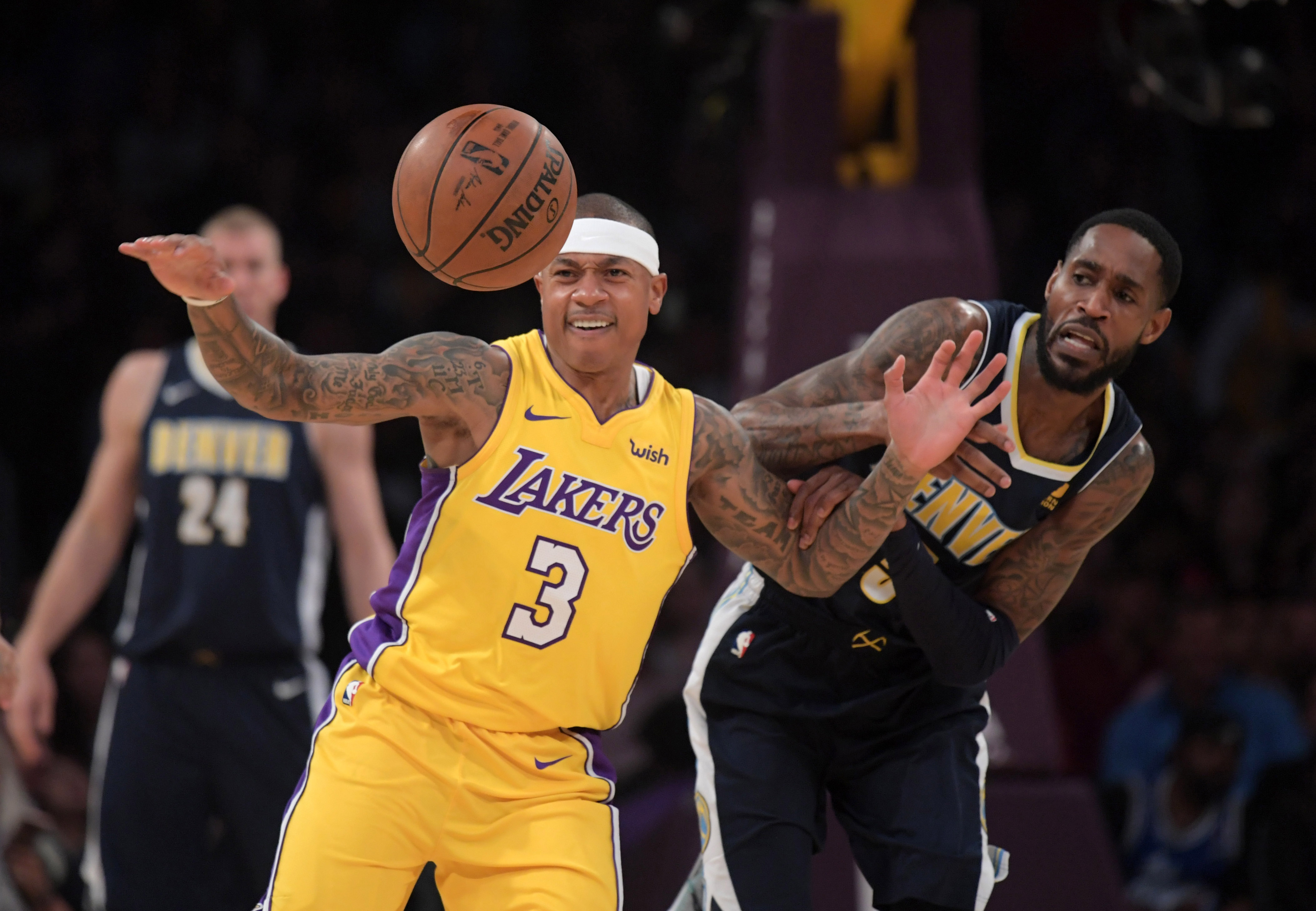 Los Angeles Lakers guard Isaiah Thomas (3) and Denver Nuggets forward Will Barton (5) battle for the ball in the first half during an NBA basketball game at Staples Center. The Lakers defeated the Nuggets 112-103.