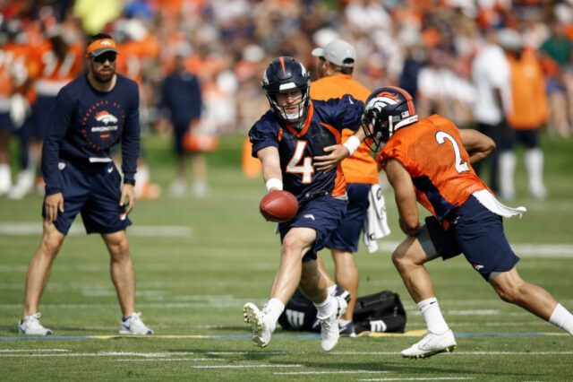 Denver Broncos quarterback Case Keenum (4) hands the ball off to running back Phillip Lindsay (2) during a drill on the first day of training camp at Paul D. Bowlen Memorial Broncos Centre.