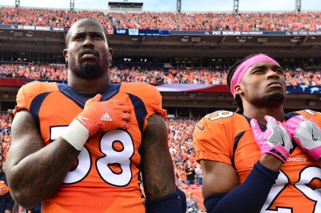 Von Miller and Bradley Roby stand for the Anthem in 2016. Credit: Ron Chenoy, USA Today Sports.