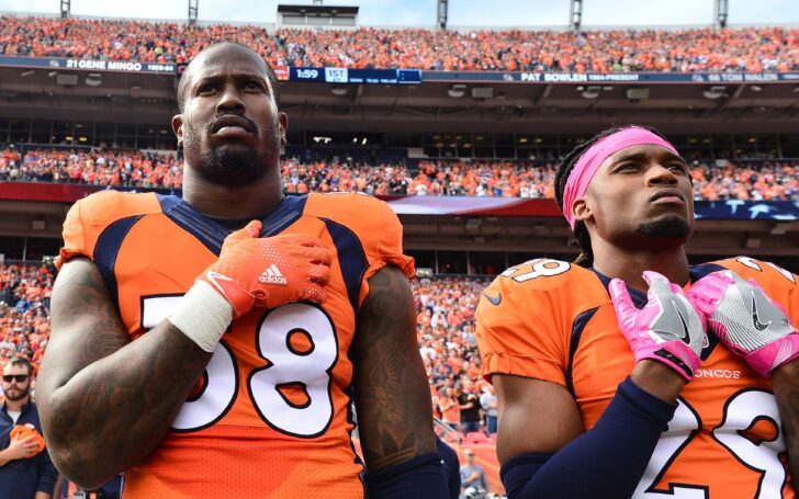 Von Miller and Bradley Roby stand for the Anthem in 2016. Credit: Ron Chenoy, USA Today Sports.