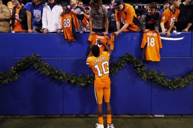 Denver Broncos wide receiver Emmanuel Sanders (10) signs autographs after the game against the Indianapolis Colts at Lucas Oil Stadium.