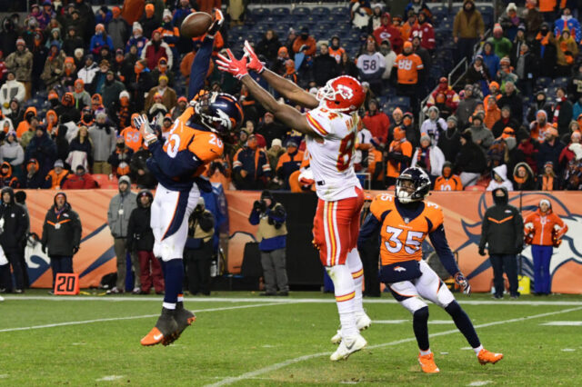 Denver Broncos defensive back Jamal Carter (20) blocks a pass intended for Kansas City Chiefs tight end Demetrius Harris (84) in the fourth quarter at Sports Authority Field at Mile High