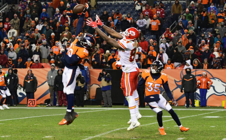 Denver Broncos defensive back Jamal Carter (20) blocks a pass intended for Kansas City Chiefs tight end Demetrius Harris (84) in the fourth quarter at Sports Authority Field at Mile High