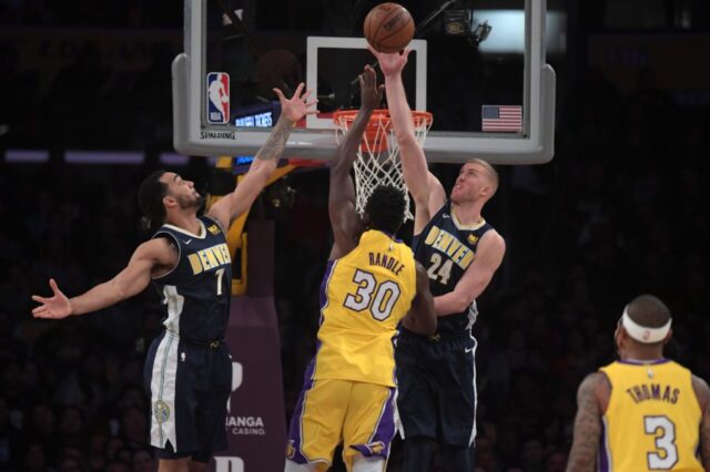 ;Los Angeles Lakers forward Julius Randle (30) is defended by Denver Nuggets center Mason Plumlee (24) and forward Trey Lyles (7) in the first half during an NBA basketball game at Staples Center.