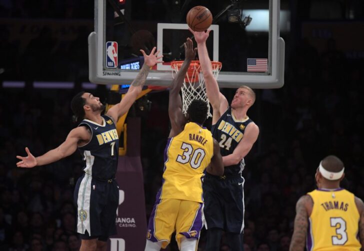 ;Los Angeles Lakers forward Julius Randle (30) is defended by Denver Nuggets center Mason Plumlee (24) and forward Trey Lyles (7) in the first half during an NBA basketball game at Staples Center.