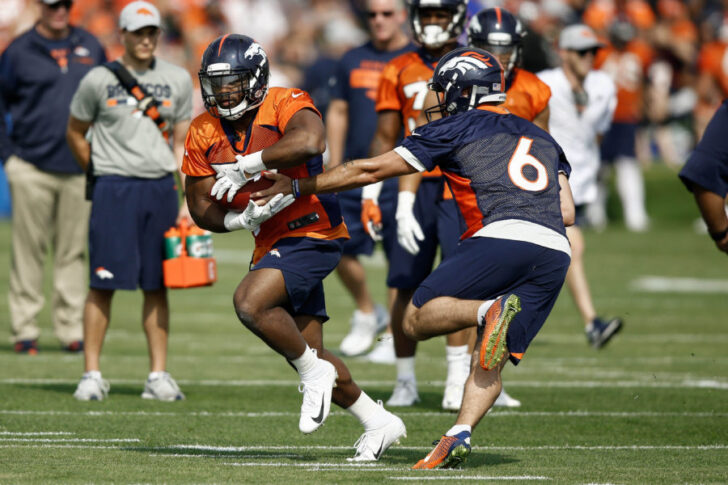 Denver Broncos quarterback Chad Kelly (6) hands the ball off to running back Royce Freeman (37) during drills on the first day of training camp at Paul D. Bowlen Memorial Broncos Centre.