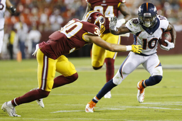 Denver Broncos wide receiver Emmanuel Sanders (10) runs with the ball past Washington Redskins defensive back Troy Apke (30) en route to a touchdown in the second quarter at FedEx Field.