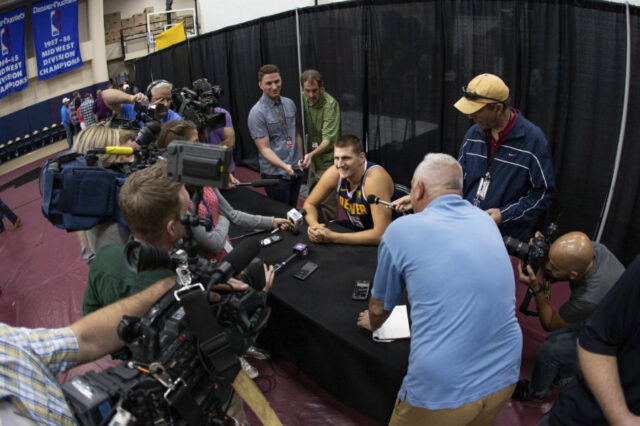Denver Nuggets center Nikola Jokic (15) answers questions during media day at the Pepsi Center.