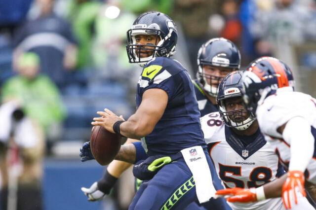 Seattle Seahawks quarterback Russell Wilson (3) looks to pass while under pressure from Denver Broncos linebacker Von Miller (58) during the first quarter in a preseason NFL football game at CenturyLink Field.