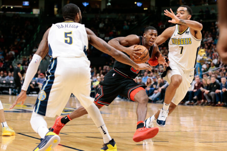 Denver Nuggets guard Will Barton (5) and forward Trey Lyles (7) defend against Chicago Bulls guard Kris Dunn (32) in the fourth quarter at the Pepsi Center.