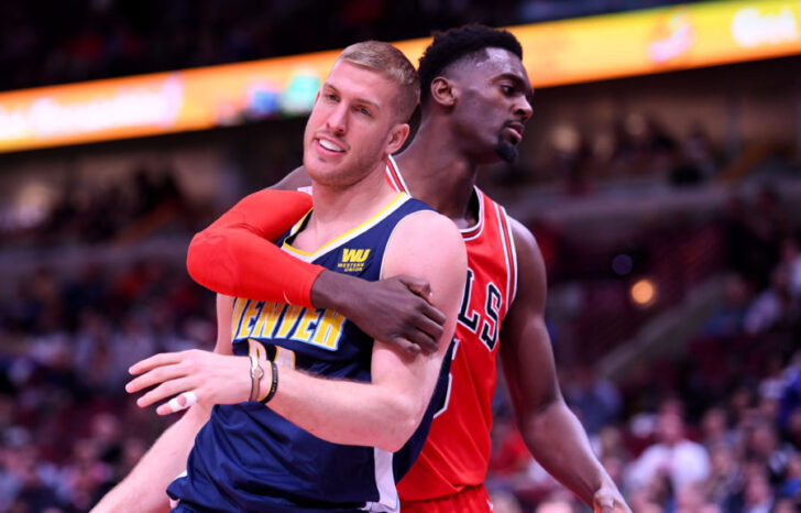Chicago Bulls forward Bobby Portis (5) fouls Denver Nuggets center Mason Plumlee (24) during the second half at the United Center.