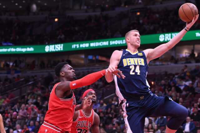 Chicago Bulls forward Bobby Portis (5) fouls Denver Nuggets center Mason Plumlee (24) during the second half at the United Center
