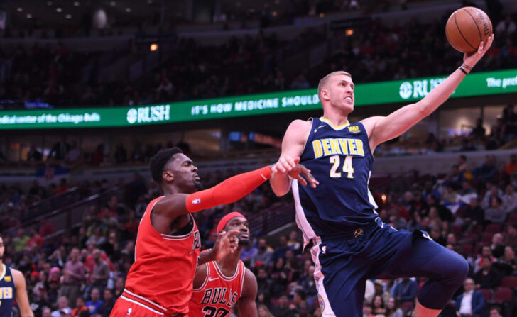 Chicago Bulls forward Bobby Portis (5) fouls Denver Nuggets center Mason Plumlee (24) during the second half at the United Center
