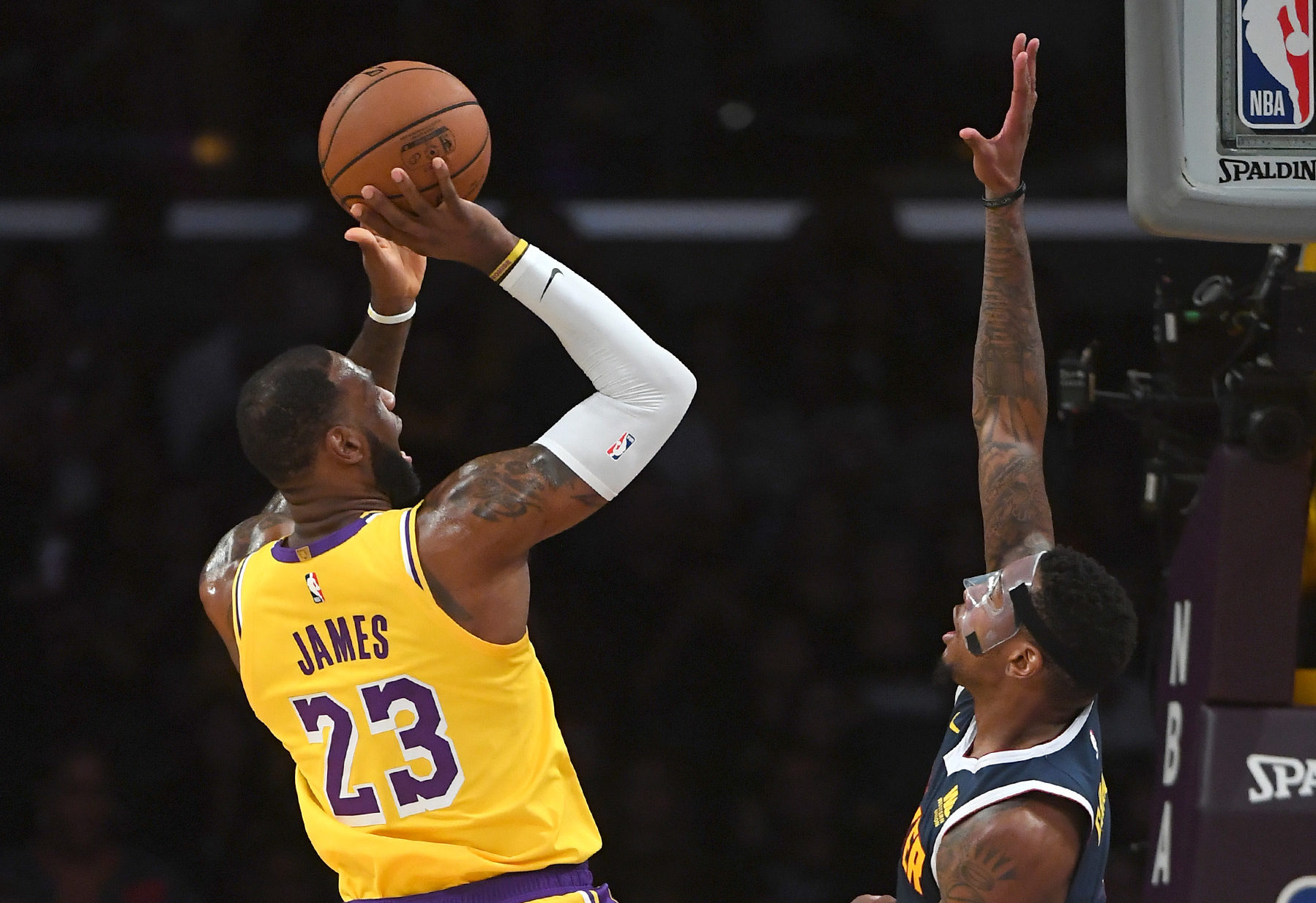 NBA: Preseason-Denver Nuggets at Los Angeles Lakers Los Angeles Lakers forward LeBron James (23) makes a shot over Denver Nuggets forward Torrey Craig (3) in the first quarter of the game at Staples Center.