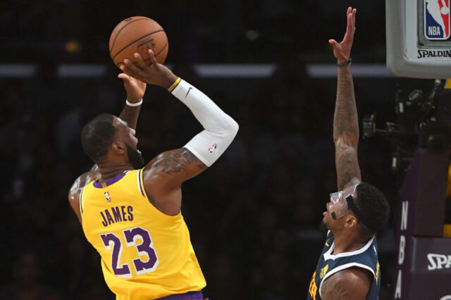 Los Angeles Lakers forward LeBron James (23) makes a shot over Denver Nuggets forward Torrey Craig (3) in the first quarter of the game at Staples Center.