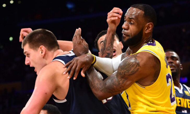 Los Angeles Lakers forward LeBron James (23) battles Denver Nuggets center Nikola Jokic (15) under the basket in the first half at Staples Center.