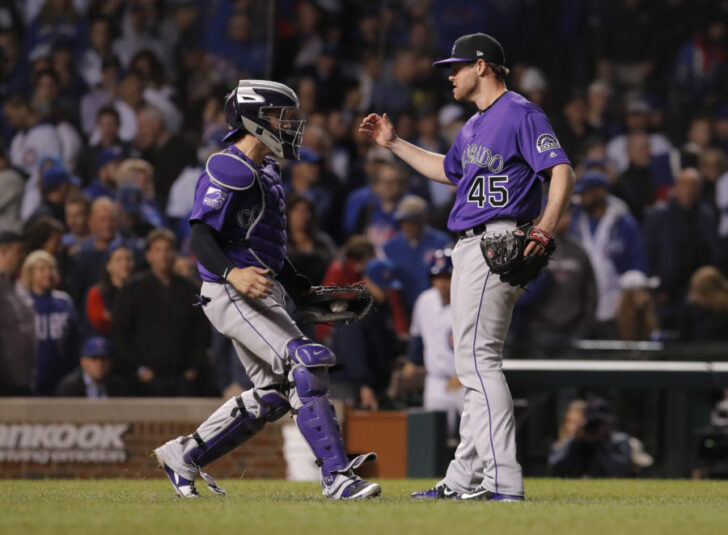 Colorado Rockies players Tony Wolters (left) and Scott Oberg (45) celebrate after defeating the Chicago Cubs in the 2018 National League wild card playoff baseball game at Wrigley Field.