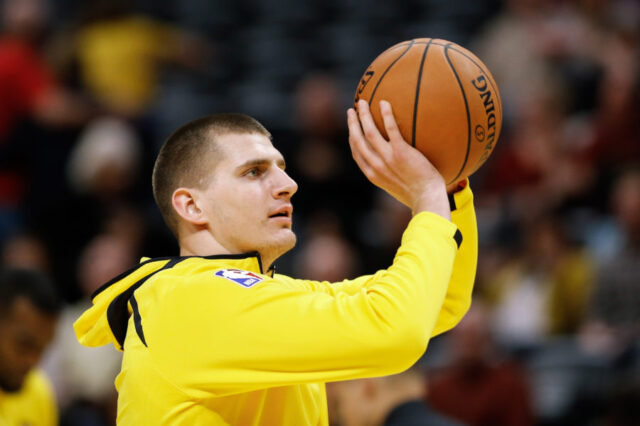 Denver Nuggets center Nikola Jokic (15) warms up before the game against the Phoenix Suns at the Pepsi Center.