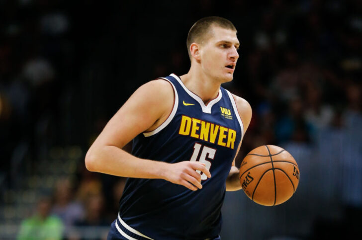 Denver Nuggets center Nikola Jokic (15) dribbles the ball up court in the first quarter against the Phoenix Suns at the Pepsi Center.