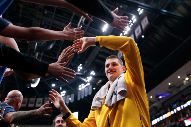 Denver Nuggets center Nikola Jokic (15) greets fans after the game against the Phoenix Suns at the Pepsi Center.