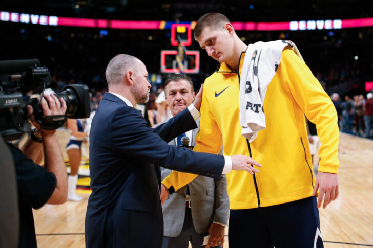 Denver Nuggets head coach Michael Malone congratulates center Nikola Jokic (15) after the game against the Phoenix Suns at the Pepsi Center.