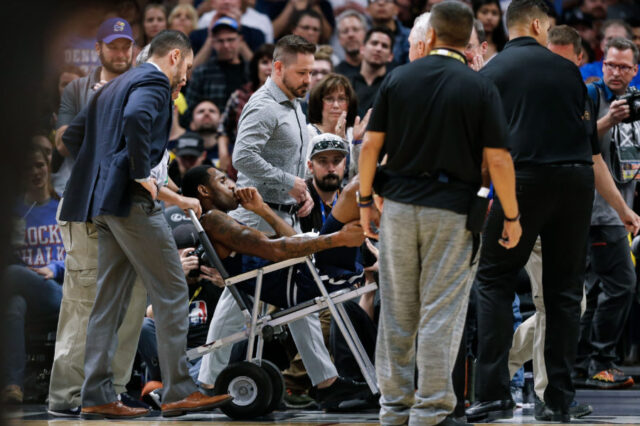 Denver Nuggets guard Will Barton (5) is carted off the court in the third quarter against the Phoenix Suns at the Pepsi Center.