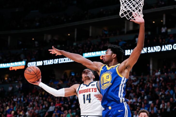 Golden State Warriors center Damian Jones (15) defends against Denver Nuggets guard Gary Harris (14) in the first quarter at the Pepsi Center.