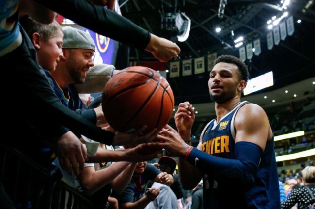 Denver Nuggets guard Jamal Murray (27) signs autographs after the game against the Boston Celtics at Pepsi Center