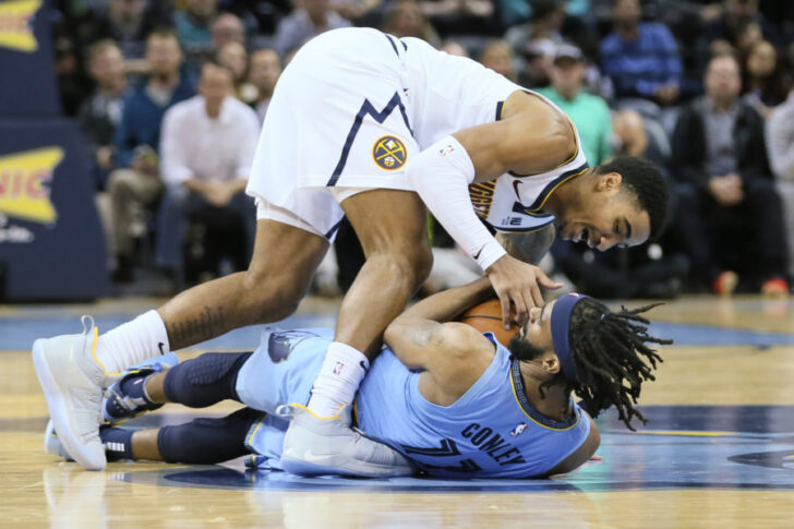 Nov 7, 2018; Memphis, TN, USA; Memphis Grizzlies guard Mike Conley (11) battles for the ball with Denver Nuggets guard Gary Harris (14) at FedExForum. Mandatory Credit: Nelson Chenault-USA TODAY Sports