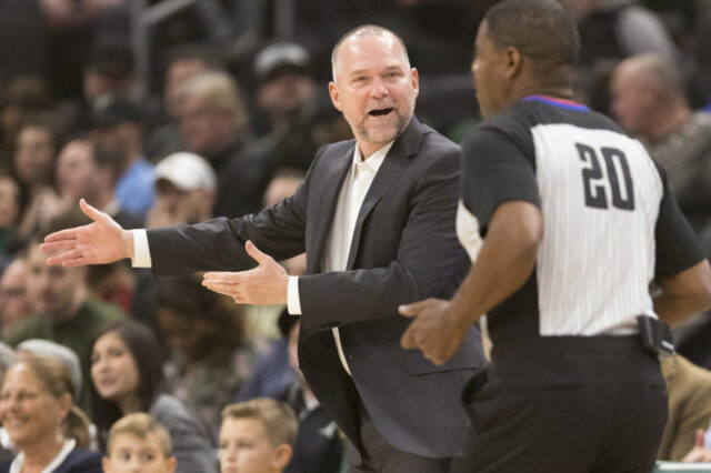Denver Nuggets head coach Michael Malone argues a call with official Leroy Richardson (20) during the first quarter against the Milwaukee Bucks at Wisconsin Entertainment and Sports Center.